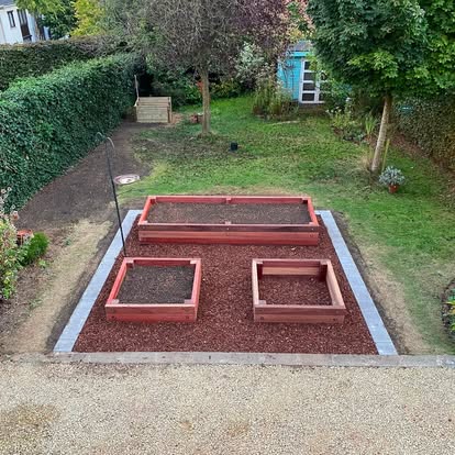 Nieuw aangelegde moestuinzone met houten bakken en kantopsluiting